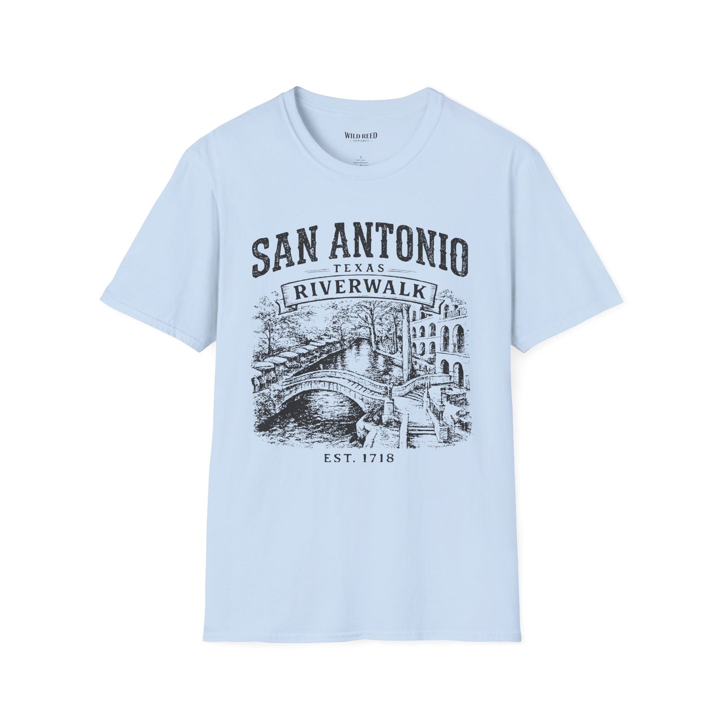 A light blue short-sleeve t-shirt with a dark gray graphic print on the front reading 'SAN ANTONIO RIVERWALK TEXAS EST. 1718' above an illustration of a river scene with a bridge.