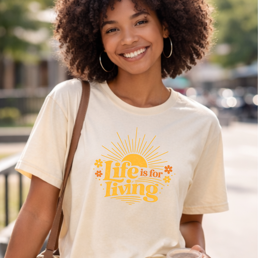 Woman wearing Life Is For Living vintage country graphic t-shirt with denim shorts and boots
