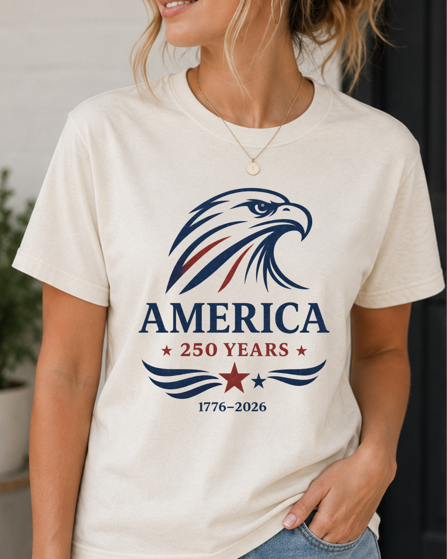 Woman wearing a vintage America 250 eagle graphic printed on a patriotic unisex t-shirt featuring a 1776-2026 commemorative design.