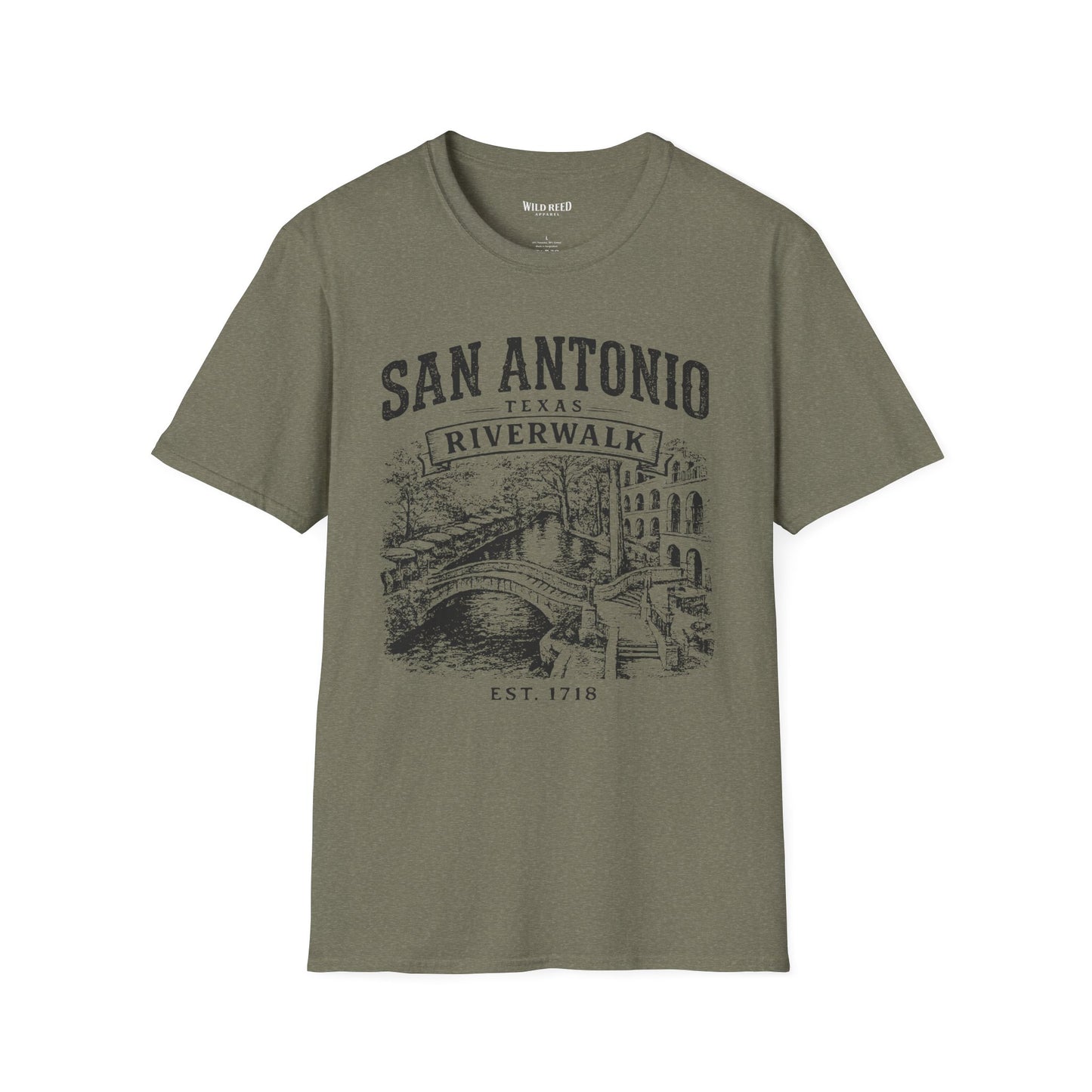 An olive green short-sleeve t-shirt with a dark gray graphic print on the front reading 'SAN ANTONIO RIVERWALK TEXAS EST. 1718' above an illustration of a river scene with a bridge.